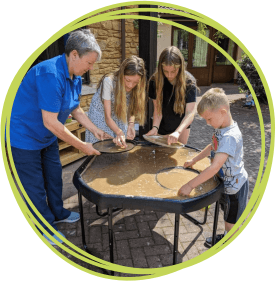 Sibs worker Sally panning for gold with children at LBH